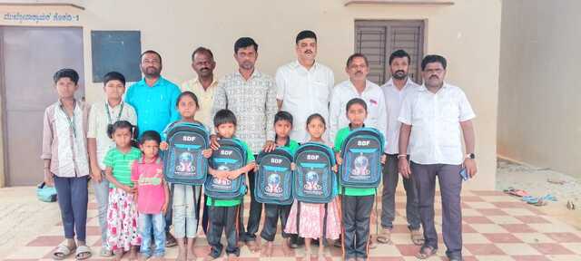 Distributed School Bags,Notebooks,Geometry box,pen and pencil.